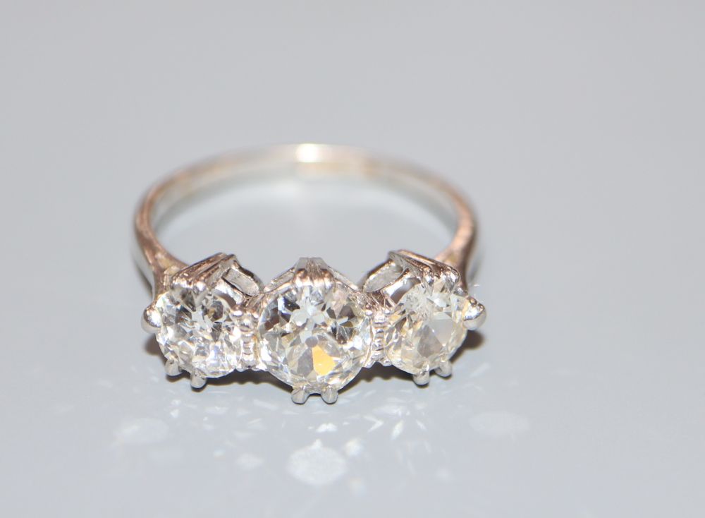 A platinum and three stone diamond ring, size N, gross 4.1 grams.